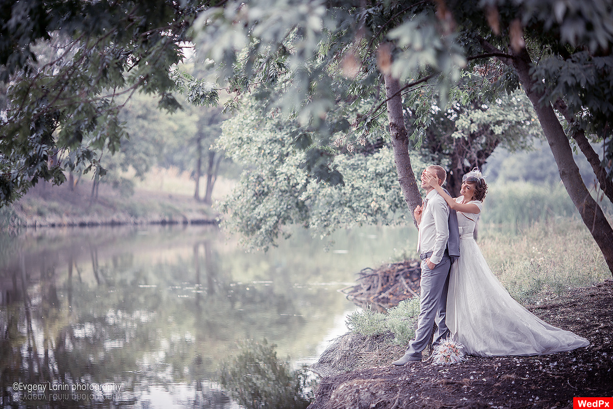 Bride and groom near the river